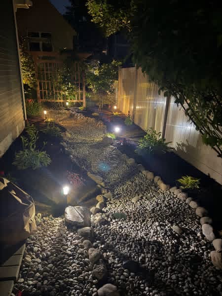 Landscape lighting along a decorative stone garden